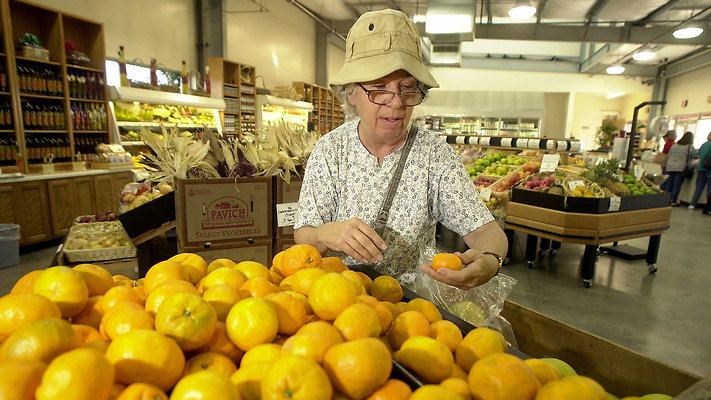 FarmStore 04 - Farm store-Karen Harvey looks over Satsuma Mandarin Oranges for sale at the Farm Store at Kellogg Ranch recently.